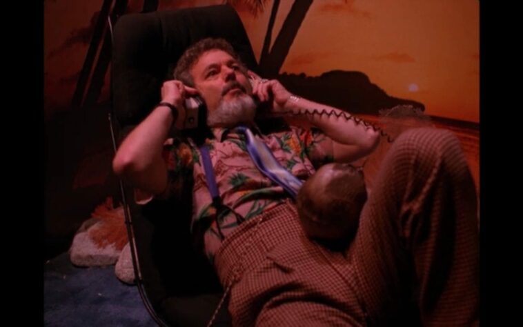 Dr Jacoby lies on a sofa with headphones on