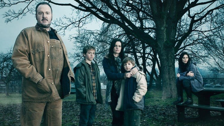 The Larsen family outside under a tree in The Killing