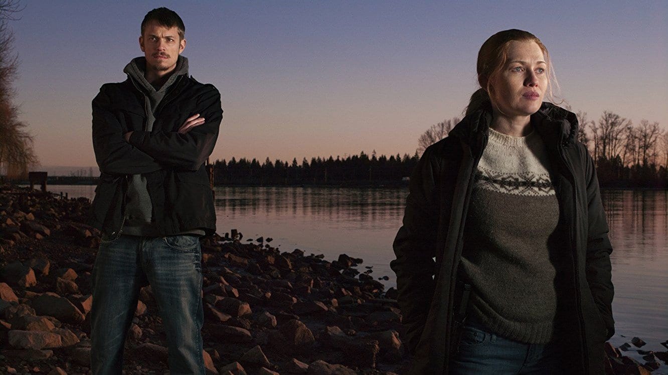 Sarah Linden and Stephen Holder in The Killing standing next to a lake at twilight
