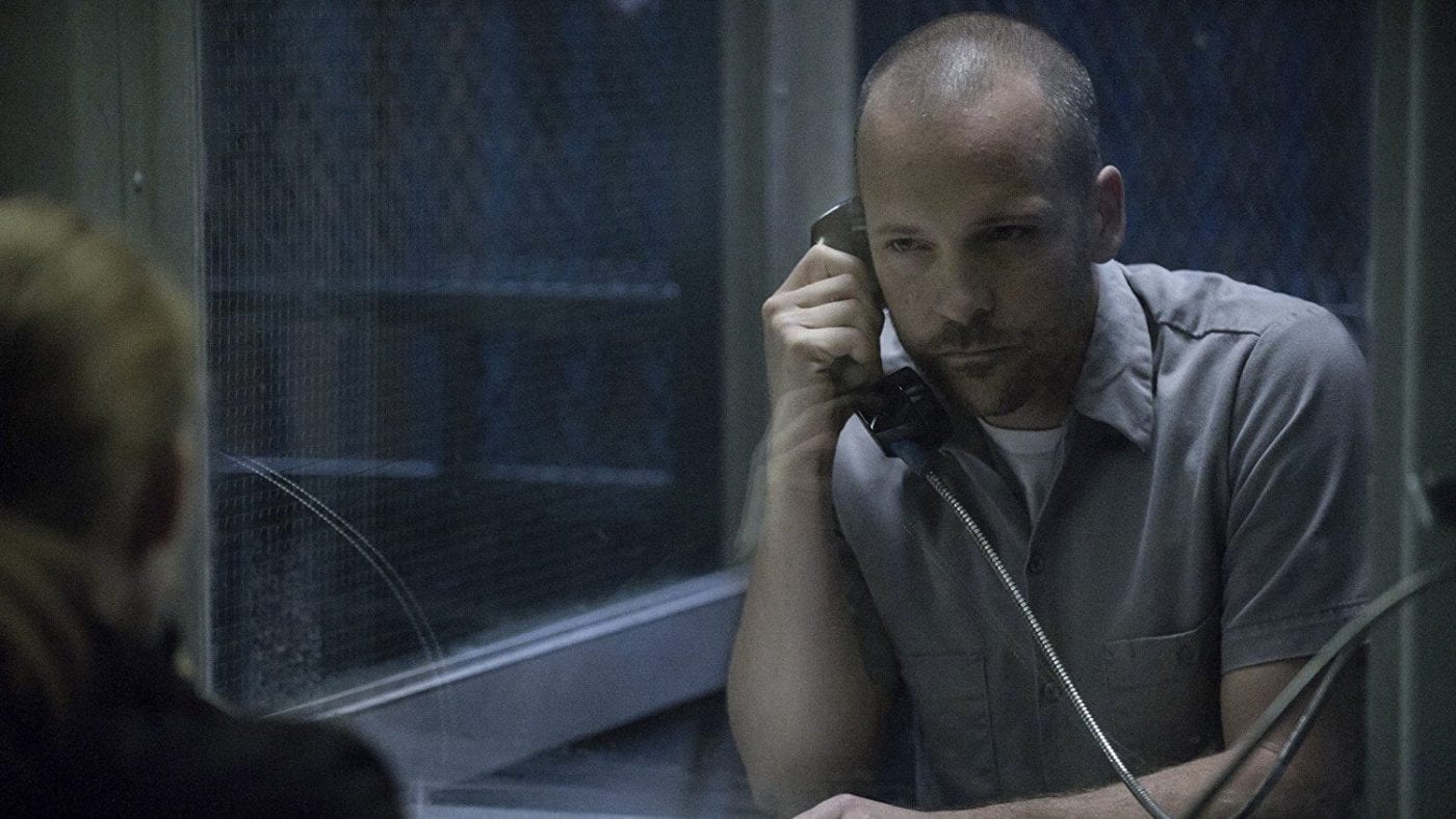 Peter Sarsgaard as Ray Seward in The Killing talking on a phone from within a prison