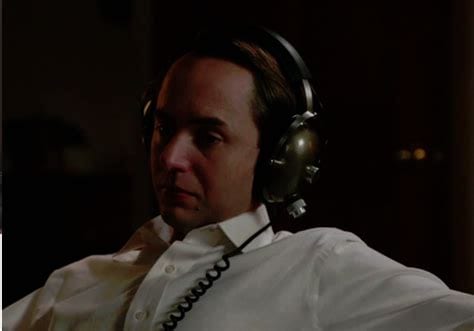 Pete Campbell wearing headphones and looking sad
