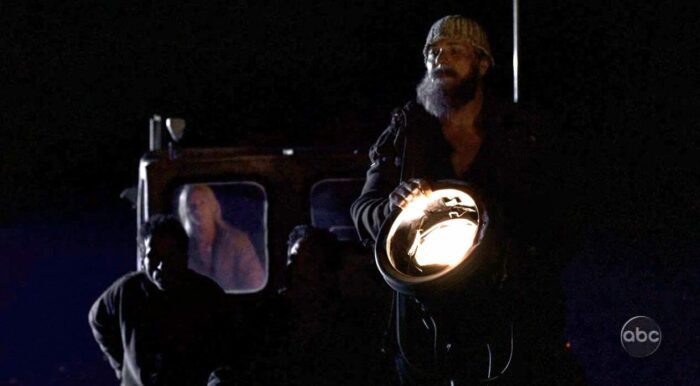 Mr. Friendly on a boat with a light in the Lost Season 1 finale, "Exodus"