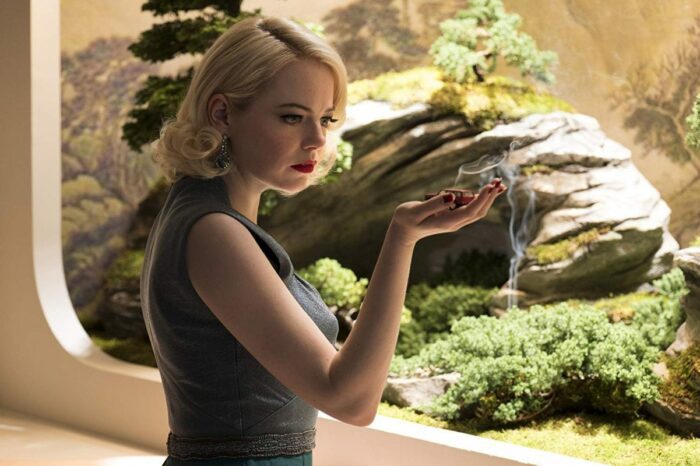 Emma Stone looks at something in her hand in Netflix's Maniac