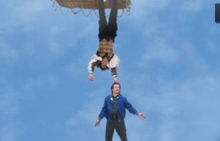 Balki holds Larry by the hair from the bottom of a hot air balloon in the finale of Perfect Strangers