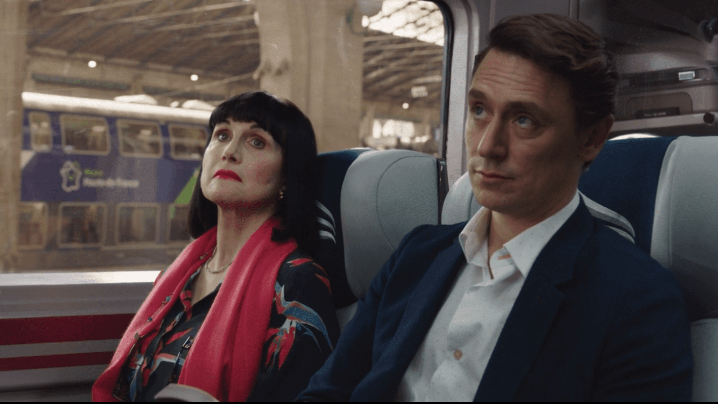 Candace and Jack sit on a train attentive to the conductor's announcement adele anderson jj feild candace jack the romanoffs