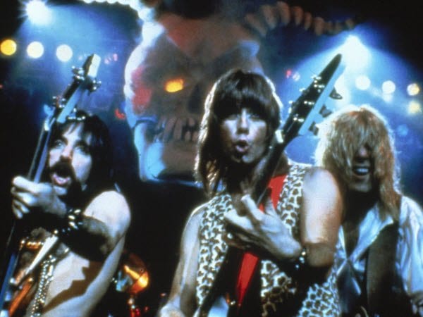 Spinal Tap gives their audience their best metal poses.