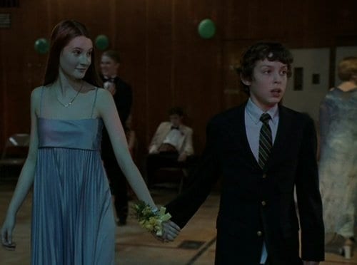 Sam takes Cindy's hand as the walk to the dance floor in the Freaks and Geeks pilot episode