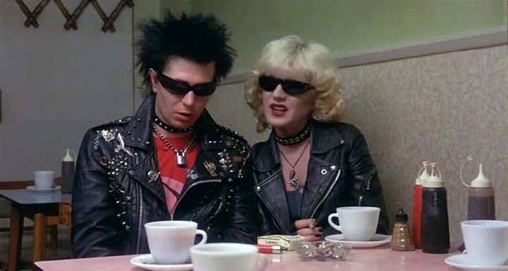 Sid and Nancy try to appear sober in the light of the diner.