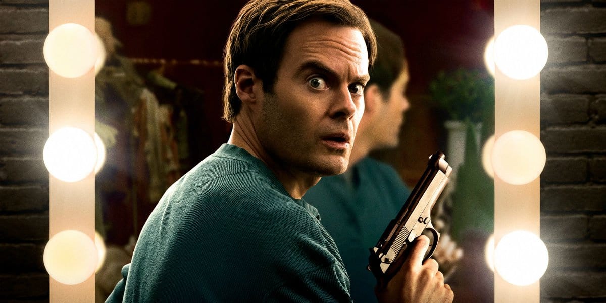 Barry (Bill Hader) holds a gun in front of a mirror in HBO's Barry