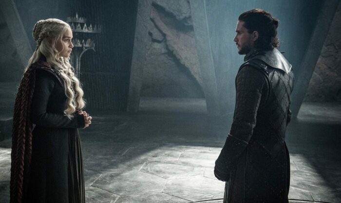 Dany and Jon Snow face each other in a drab room