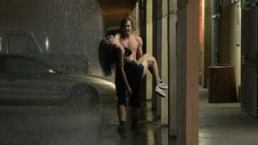 TJ (Griffin Powell-Arcand) carries Sasha (Sivan Alyra Rose) in the rain after her heart attack