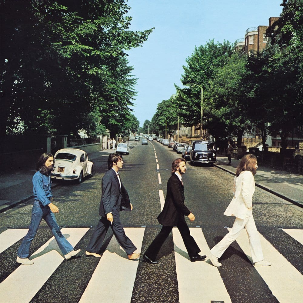 The Beatles Abbey Road album cover showing John Lennon Ringo Starr Paul McCartney and George Harrison crossing a London crosswalk