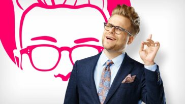 Adam Conover raises a finger in a promo shot for Adam Ruins Everything