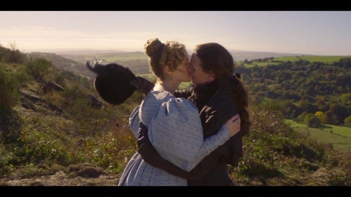 Ann Walker (Sophie Rundle) and Anne Lister (Suranne Jones) share a passionate kiss on the hillside in Gentleman Jack. 