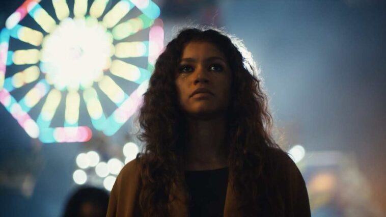 Rue at the carnival with a Ferris wheel in the background in Euphoria