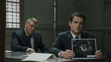Bill Tench and Holden Ford sit at a table in prision in Mindhunter