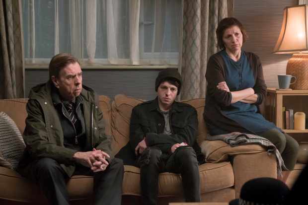 Ed, Mary and Sam sit on a sofa looking pensive