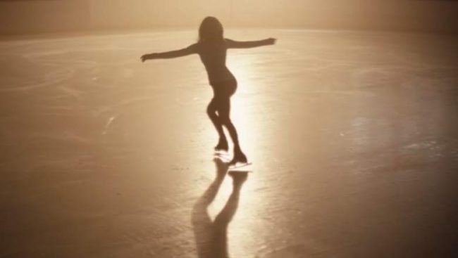 Cassie silhouetted against light while ice skating.