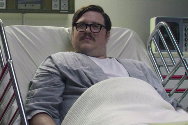 Ed Kemper sits in a hospital bed in Mindhunter
