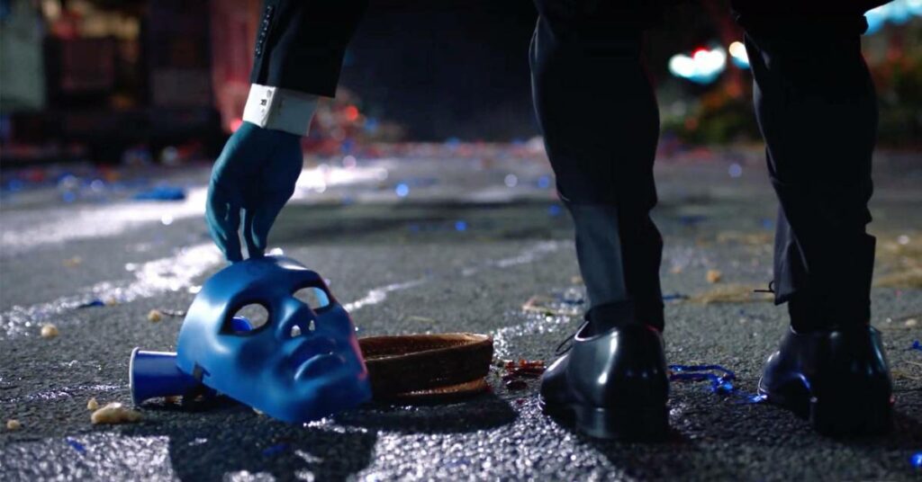 Dr. M in the new HBO series picks up a blue mask off the street