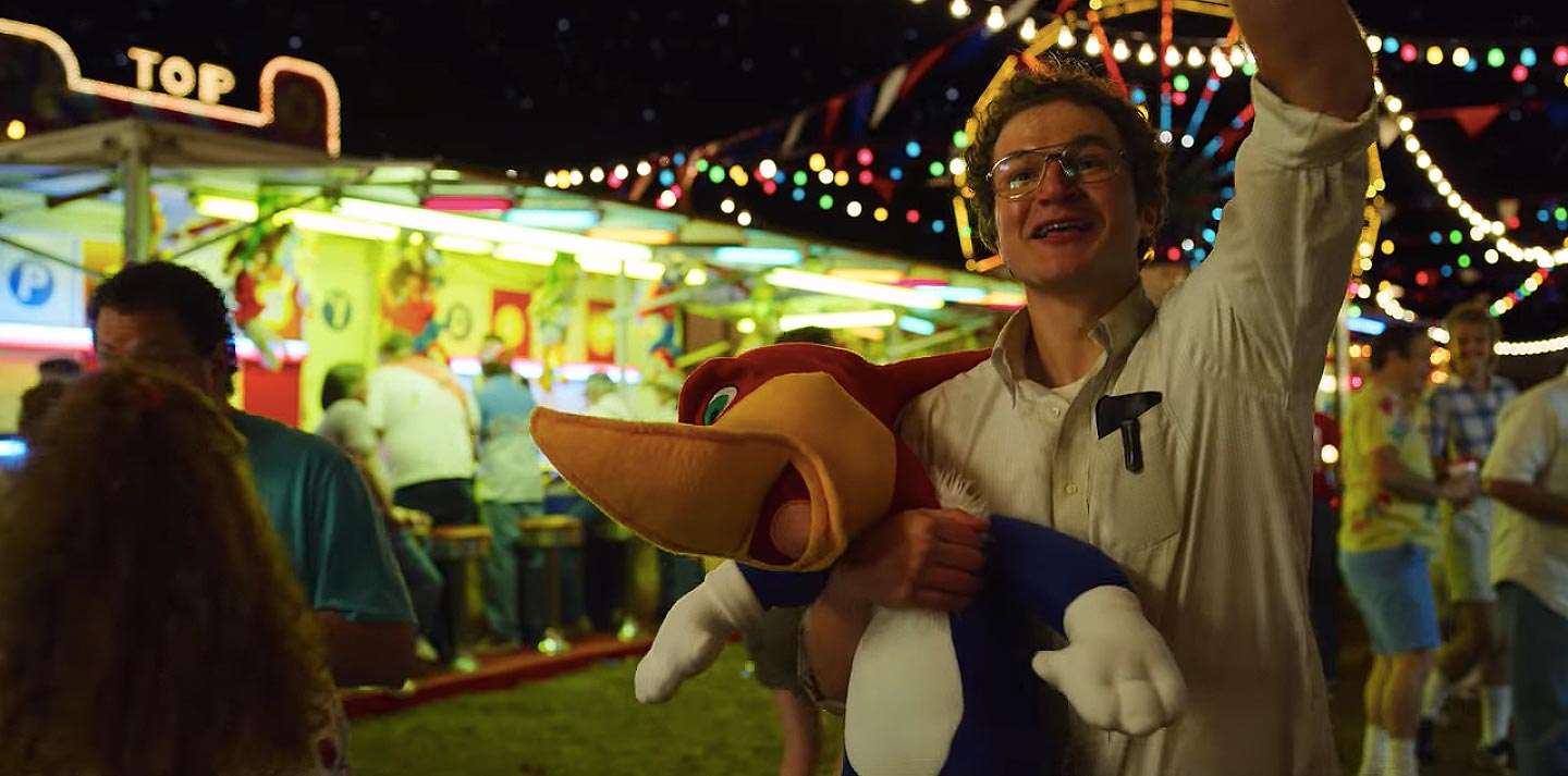 At the fair, Alexei holds a Woody Woodpecker toy and waves