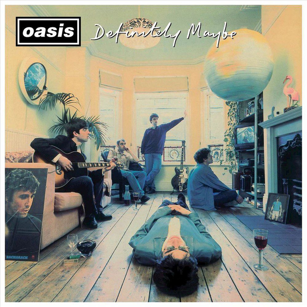 The Oasis band members sit in a flat as if they're in between writing songs on the cover of Definitely Maybe.