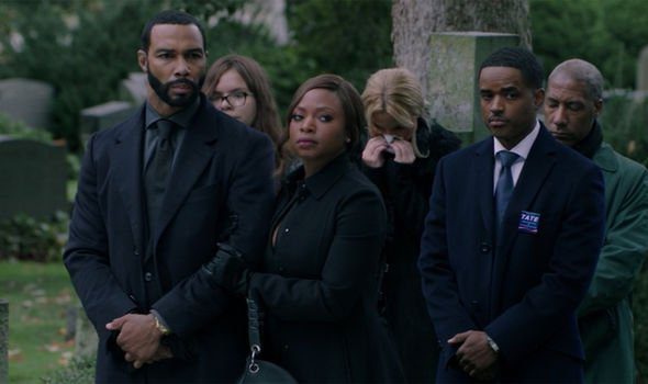 Tasha holds Ghost's arm at Angela's funeral as Councilman Tate stands next to them with his hands folded