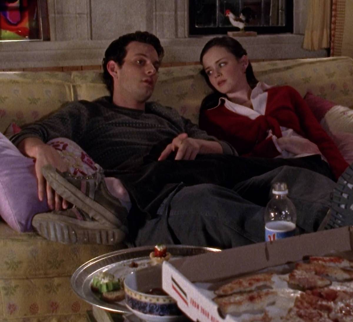 Marty and Rory lie on the couch in front of a pizza box
