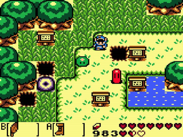 Link stands in a field with a few signs as well as a green slime and a pink slime