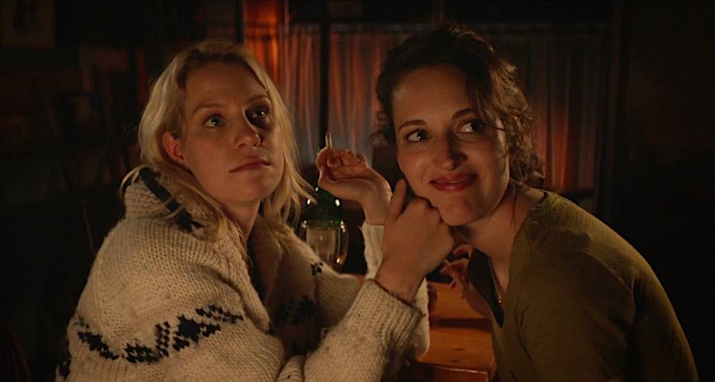 Boo touches Fleabag's face as they share a quiet moment in the cafe