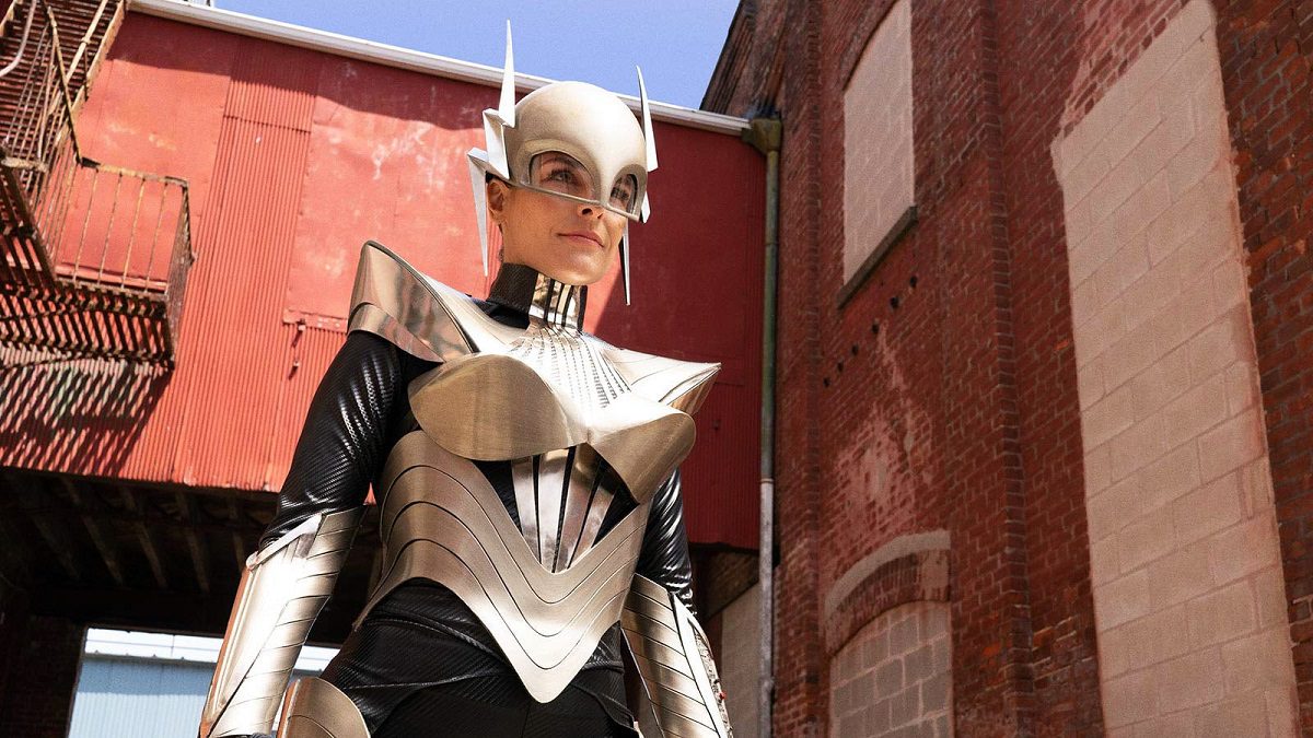 Miss Lint in her Joan of Arc costume, standing in a brick alley.