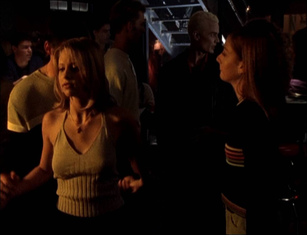 Buffy, Xander and Willow dance at the Bronze while Spike lurks behind them.