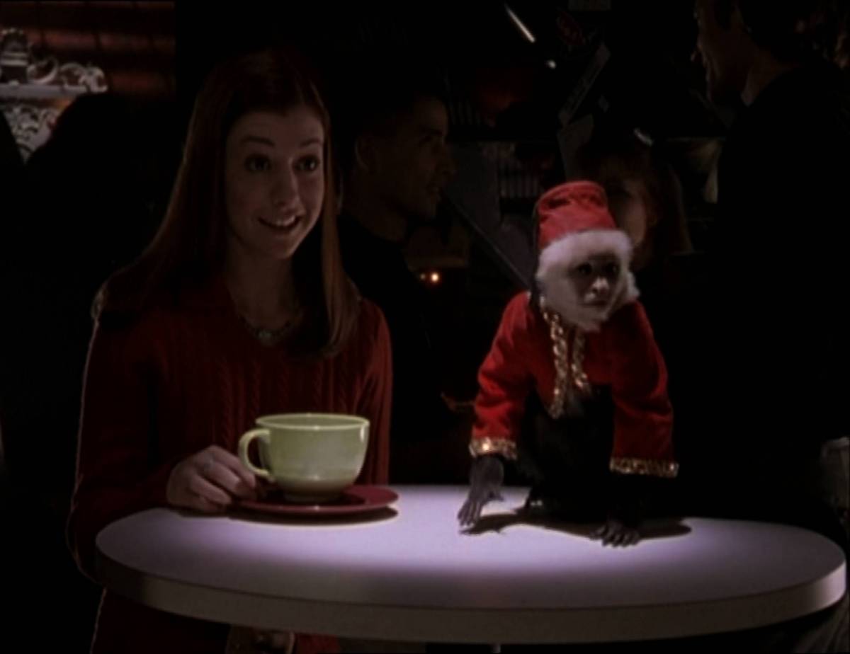 Willow sits at a table with a monkey.