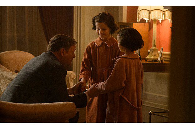 A young Margaret and Elizabeth talk with their father late at night as he sits in a chair