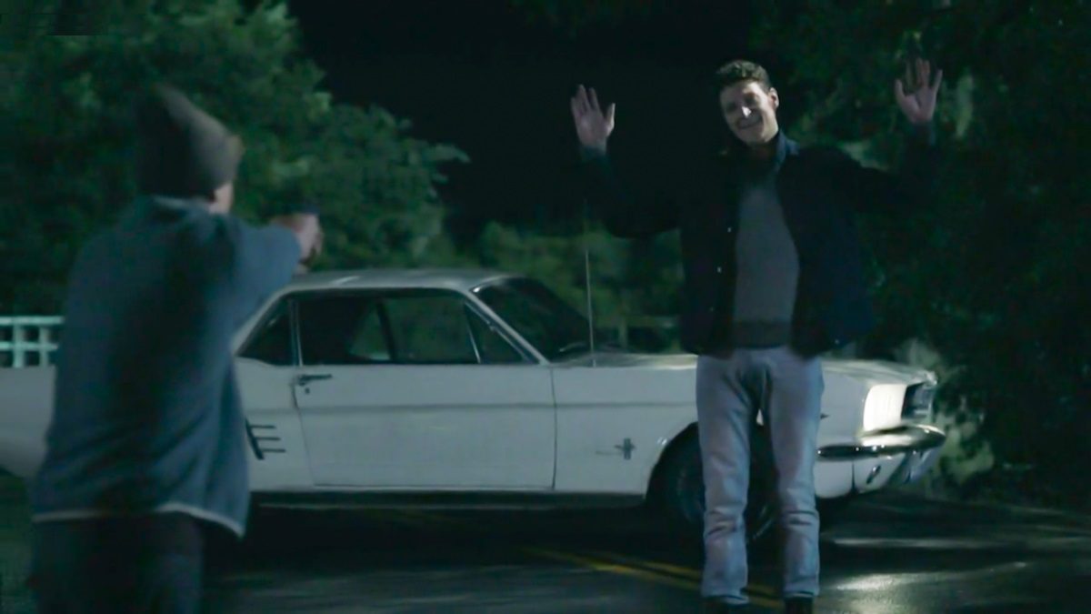 Morris stands in front of his car at night, hands up, as Pete holds a gun on him. [Mr. Mercedes S03E06]