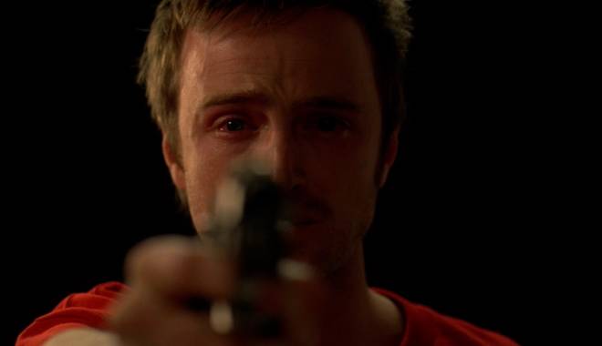 Jesse tears up as he points a gun towards Gale Boetticher