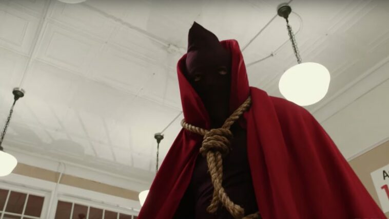 In American Hero Story, the noose-wearing Hooded Justice stands over a thug