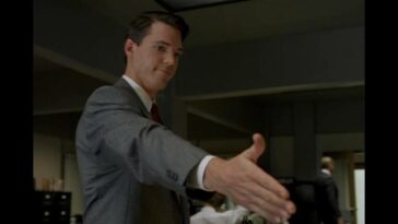 Alex Krycek, reaches out overdramatically to offer to shake Fox Mulder's hand in their tense first meeting.