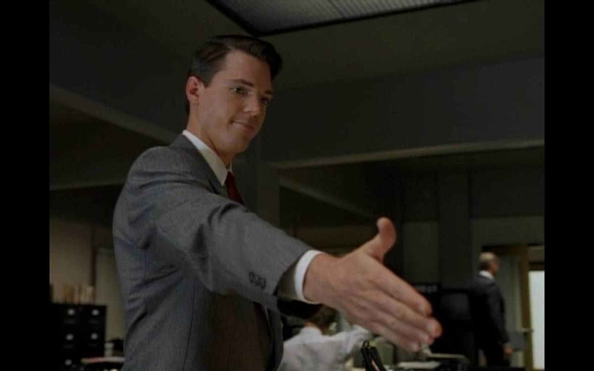 Alex Krycek, reaches out overdramatically to offer to shake Fox Mulder's hand in their tense first meeting.