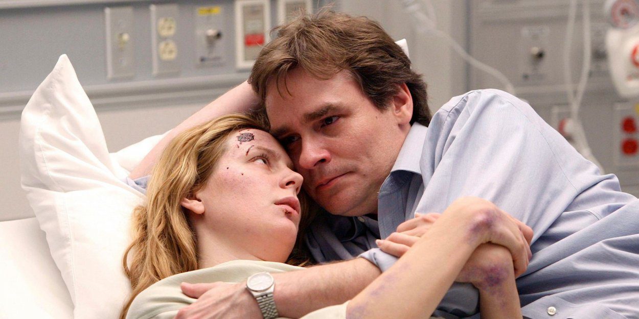 An emotional Wilson holds Amber, who is cut up and bruised, in a hospital bed