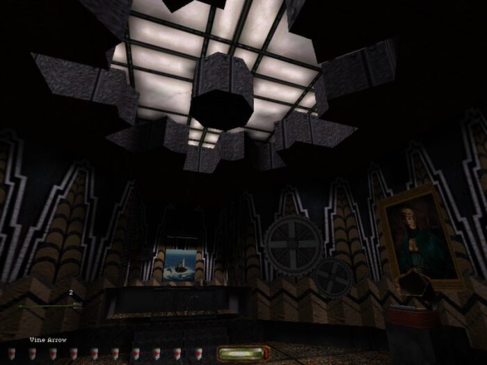 Garret stands in an industrialized room with gears on the walls and a few portraits of individuals. In the ceiling there is a giant skylight.