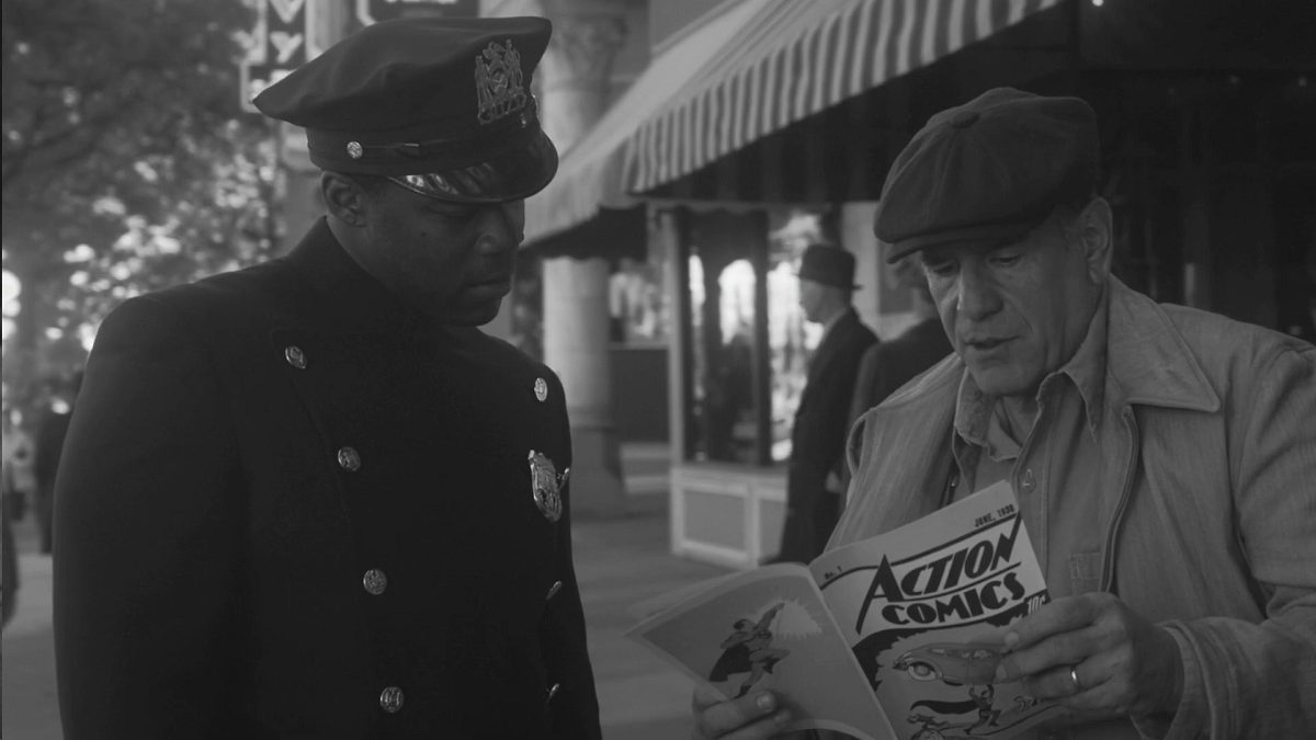 Watchmen - Officer Reeves and the newsstand guy look through a copy of Action Comics No. 1