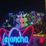 A neon sign reading La Concha features seahorses