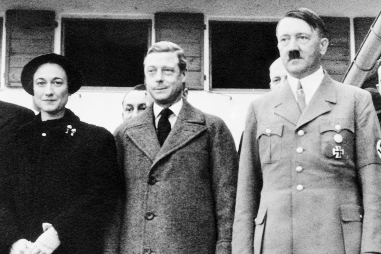A black and white photo of Wallis Simpson and Edward VIII meeting Hitler 
