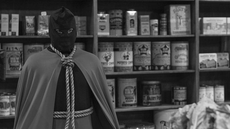 Hooded Justice stands in the convenience store.