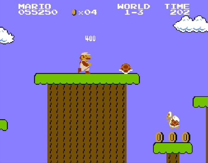 Mario kicks a turtle shell off a ledge attempting to take out the flying Koopa Trooper.