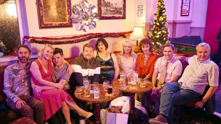 The Shipmans and the Wests pose for a family photo in the pub at christmas