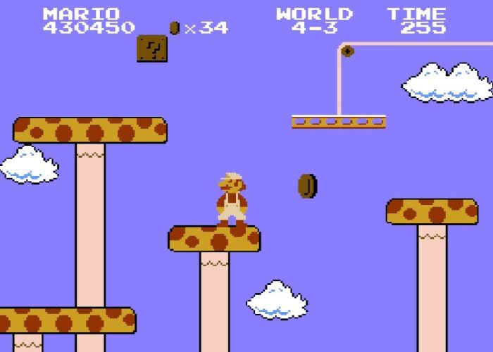 Super Mario stands on giant yellow and red-spotted mushrooms that act as platforms.