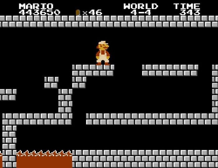 World 4-4. Pictured, Super Mario is inside the standard level ending castle location featuring gray bricks and lava pits.