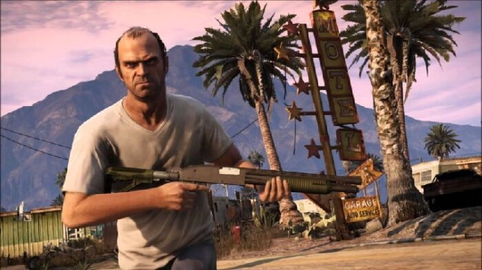 Trevor Phillips, a demented lunatic, and one of your three playable characters is shown here rampaging through a motel parking lot. The balding man, in a white t shirt, is brandishing a shotgun and an angry look on his face. 